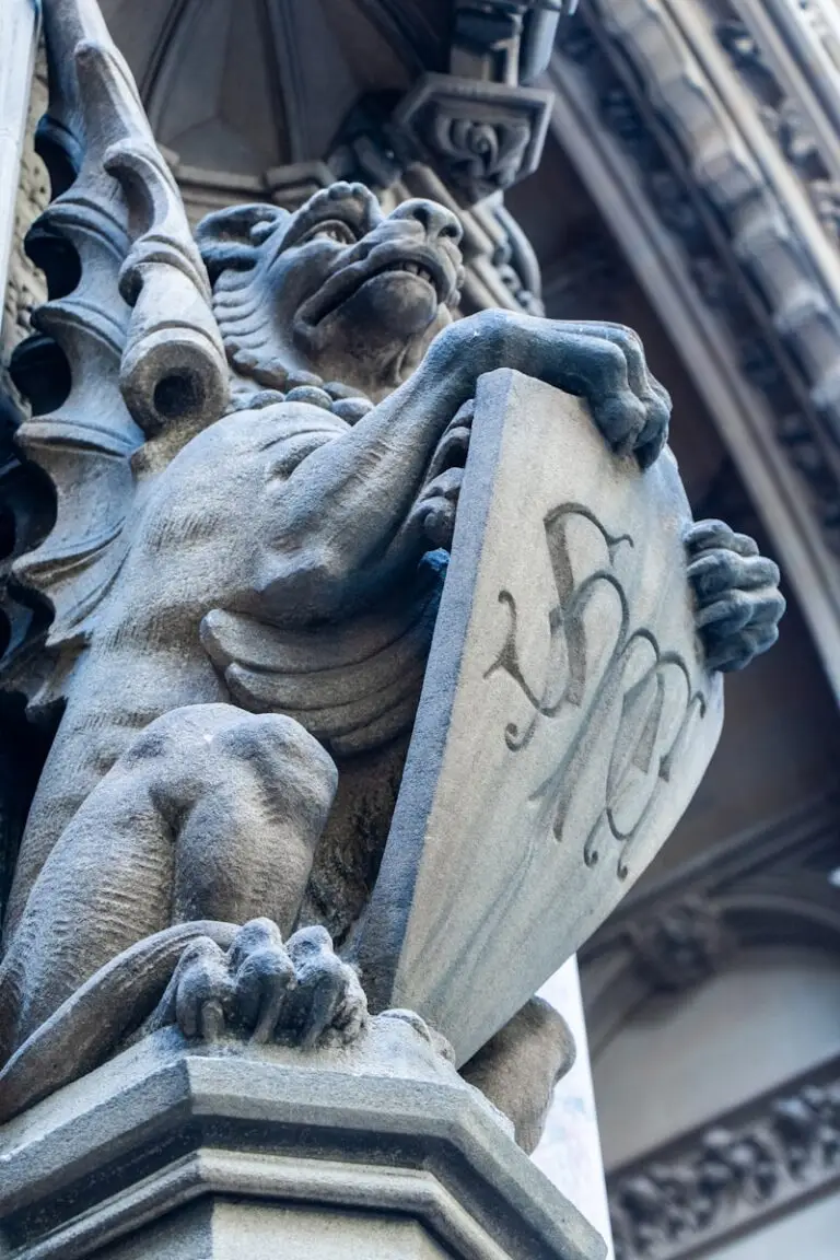 a close up of a gargoyle statue on a building
